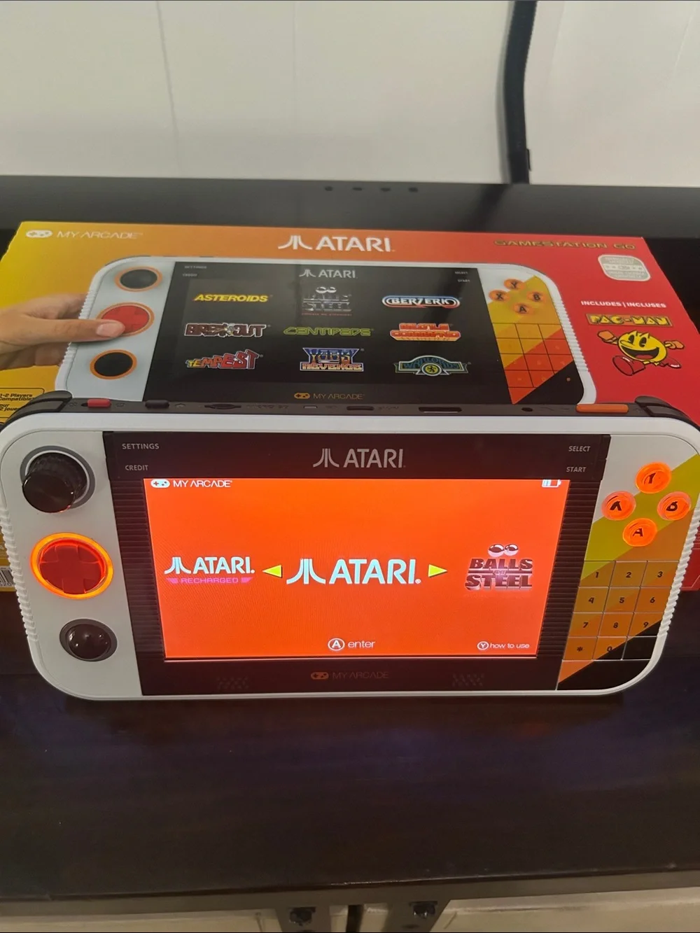 Atari Handheld Gaming Console in White and Orange